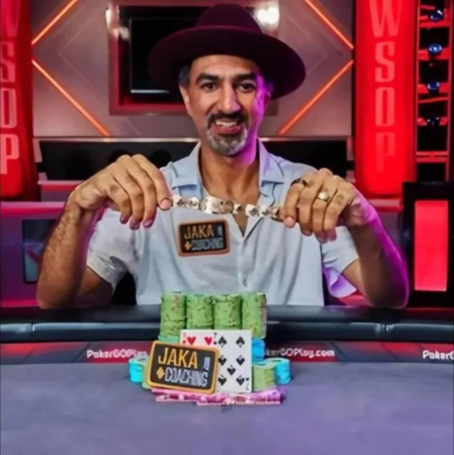 A Thomas Boivin student holding a World Series of Poker bracelet at the winner's table